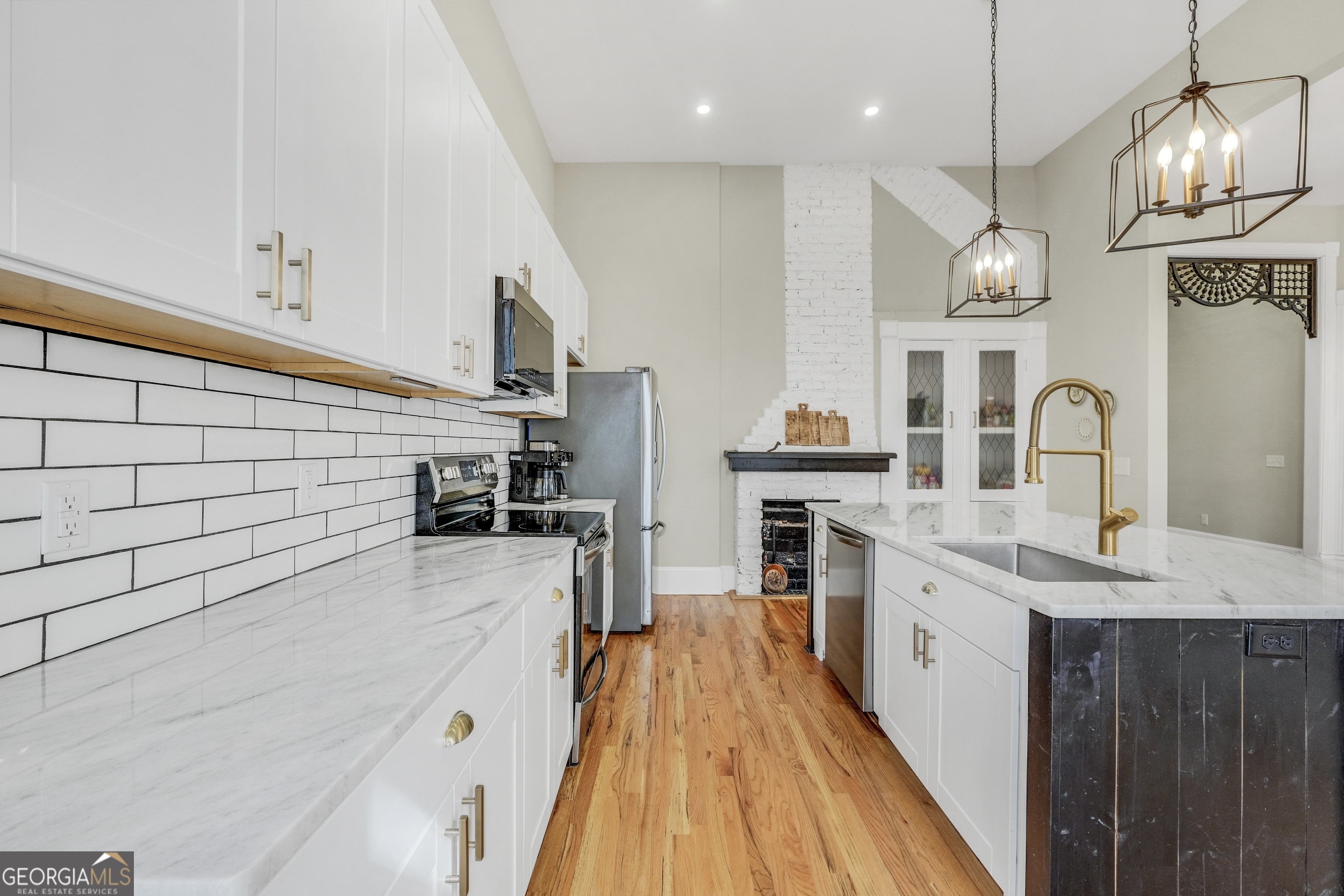 263 Julia Street Monticello, GA 31064 - Photo 13 of 48 a kitchen with stainless steel appliances a stove sink and cabinets