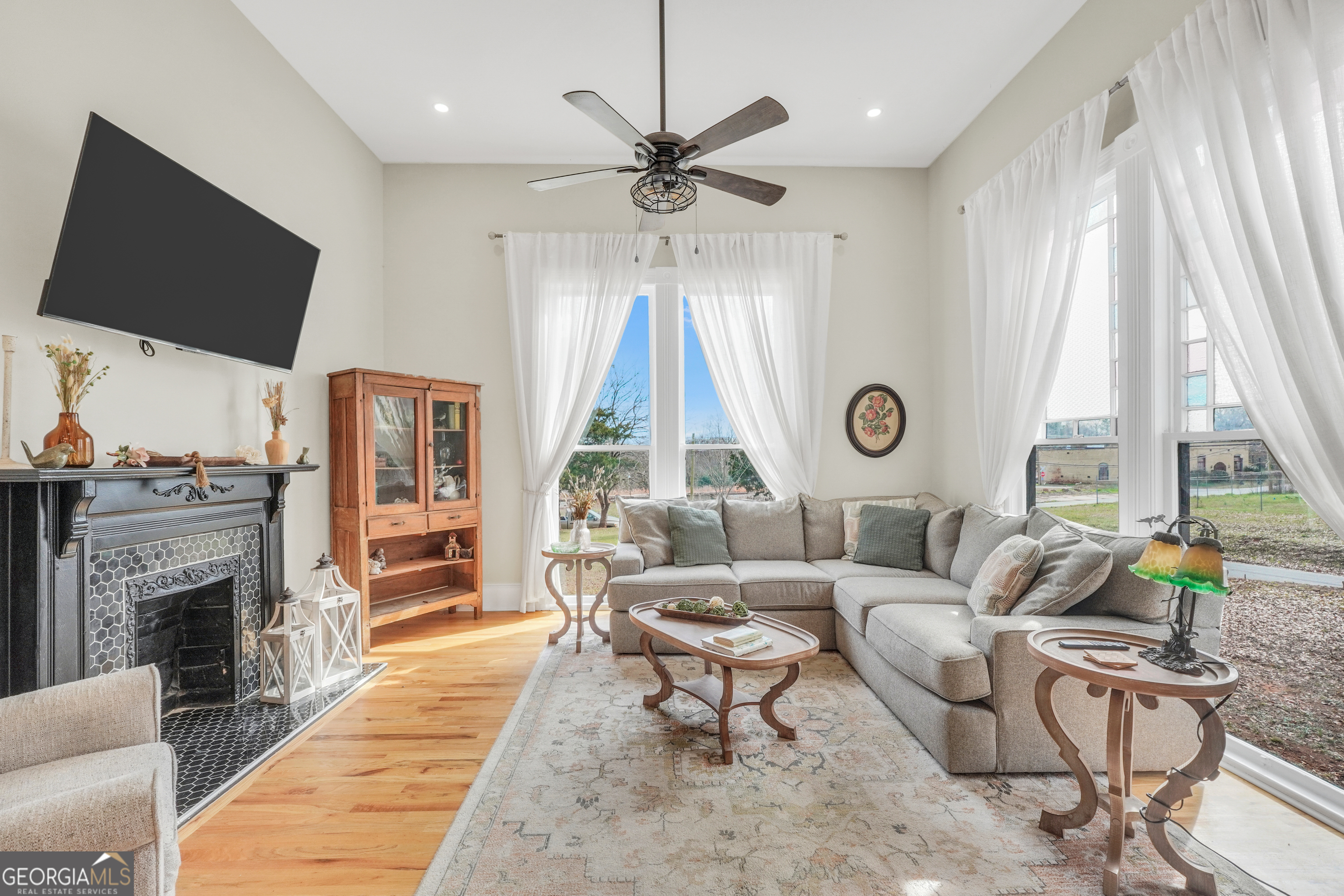 263 Julia Street Monticello, GA 31064 - Photo 21 of 48 a living room with furniture a fireplace and a flat screen tv