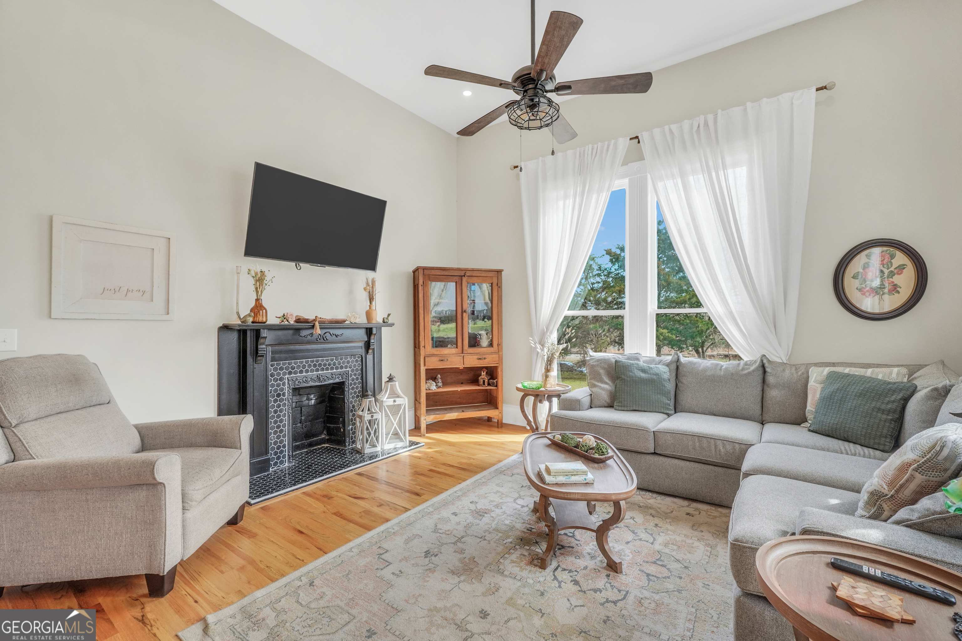 263 Julia Street Monticello, GA 31064 - Photo 22 of 48 a living room with furniture a fireplace and a flat screen tv
