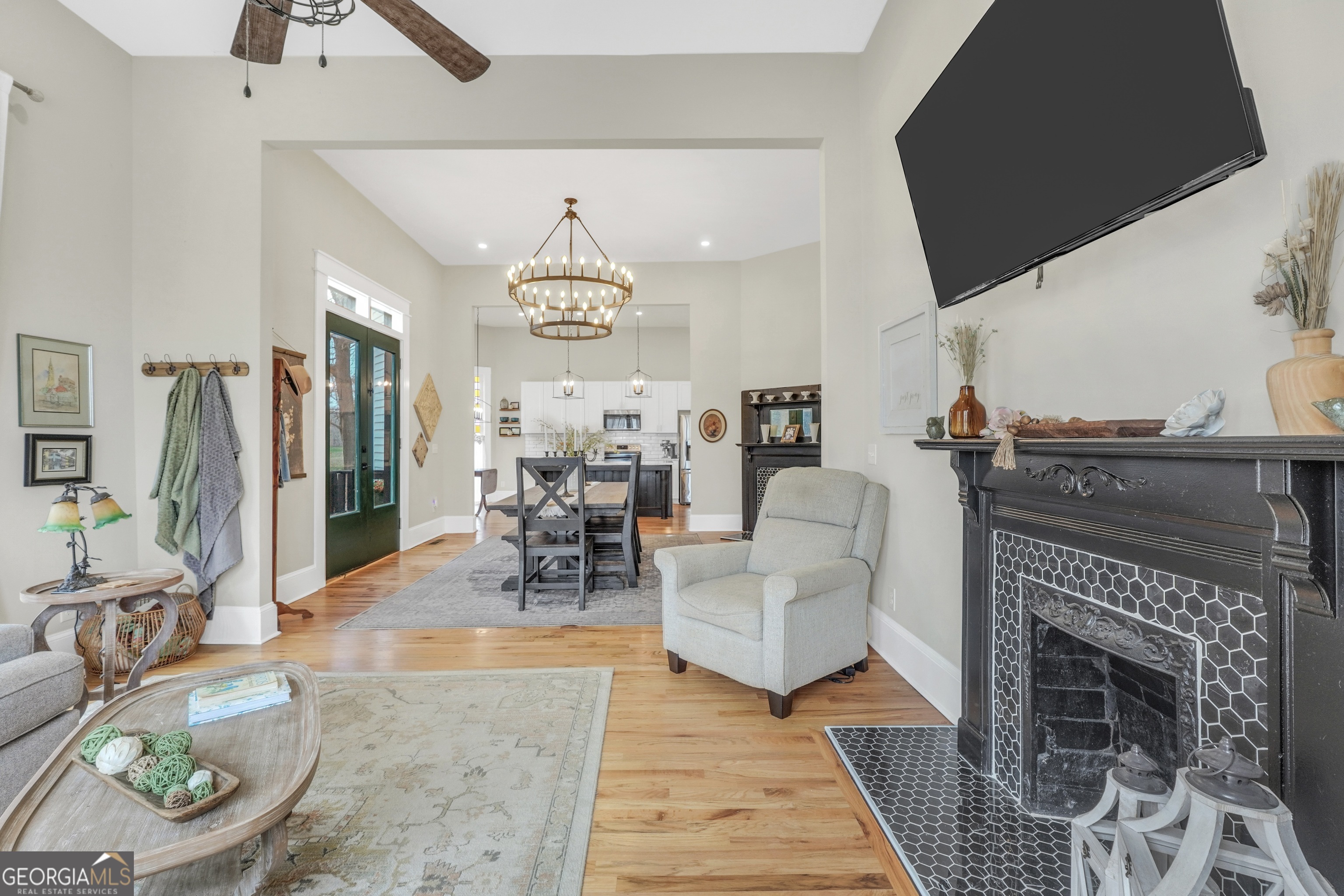 263 Julia Street Monticello, GA 31064 - Photo 23 of 48 a living room with furniture a fireplace and a chandelier