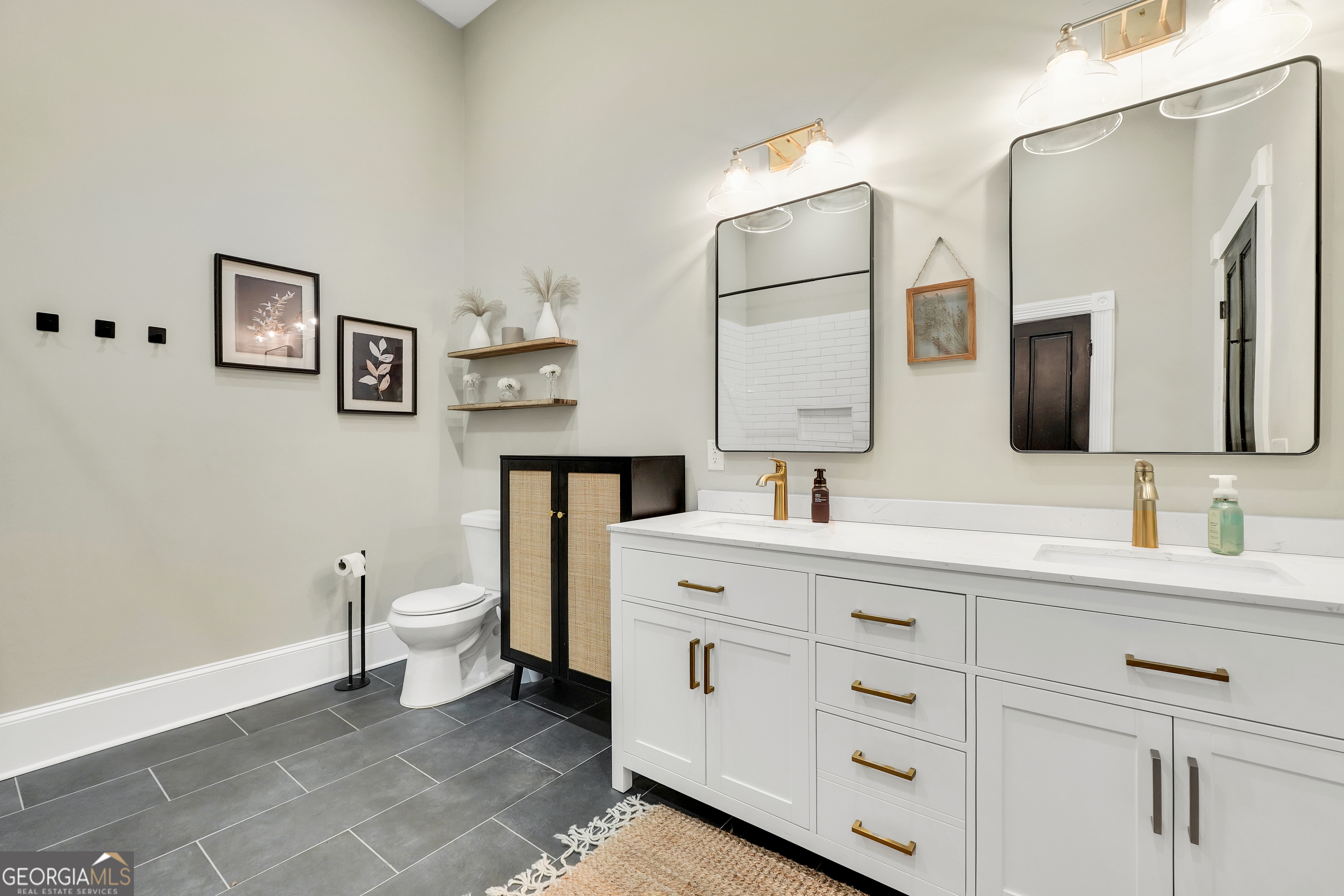 263 Julia Street Monticello, GA 31064 - Photo 29 of 48 a spacious bathroom with a toilet sink double and mirror