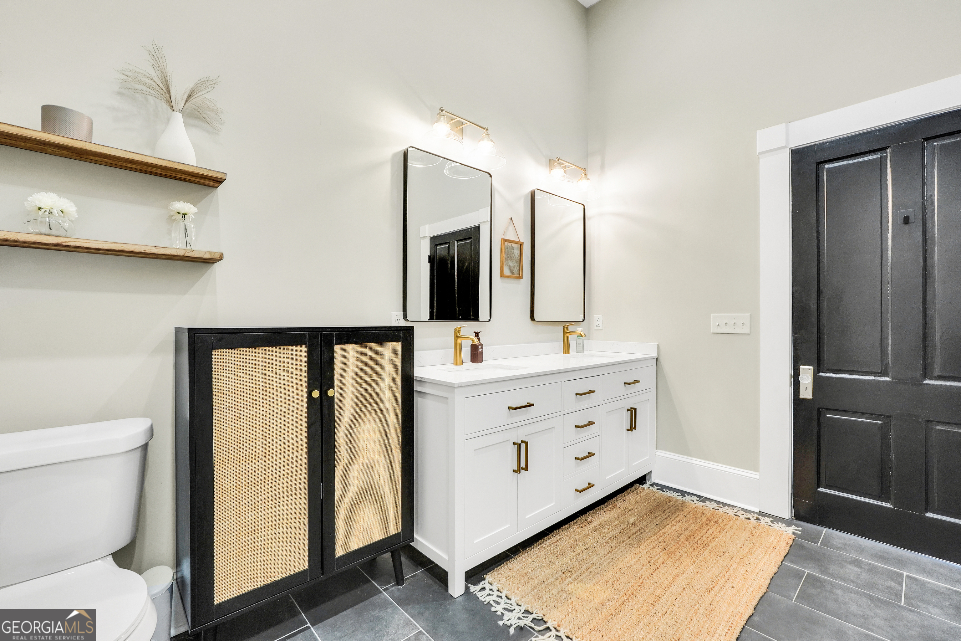 263 Julia Street Monticello, GA 31064 - Photo 31 of 48 a bathroom with a sink a toilet and mirror