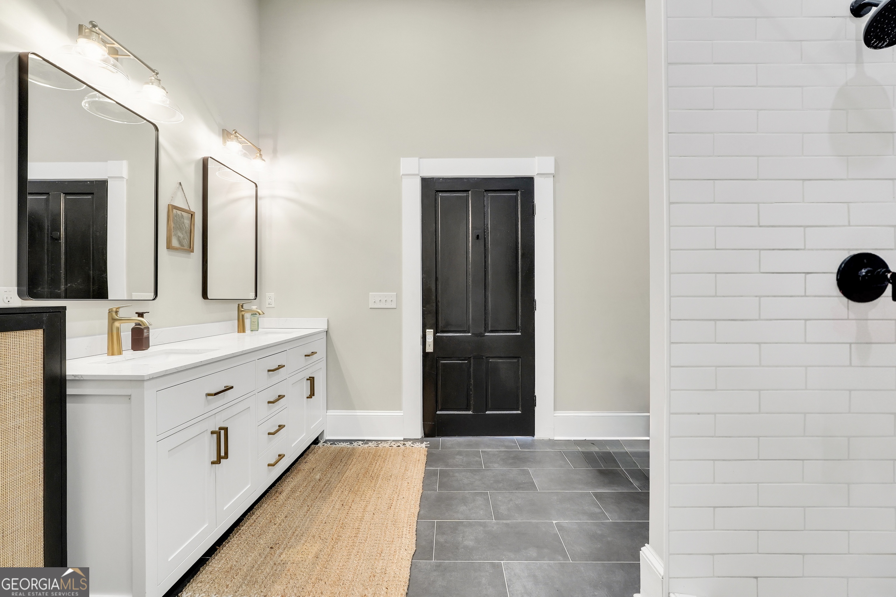 263 Julia Street Monticello, GA 31064 - Photo 33 of 48 a bathroom with a double vanity sink a mirror and a shower