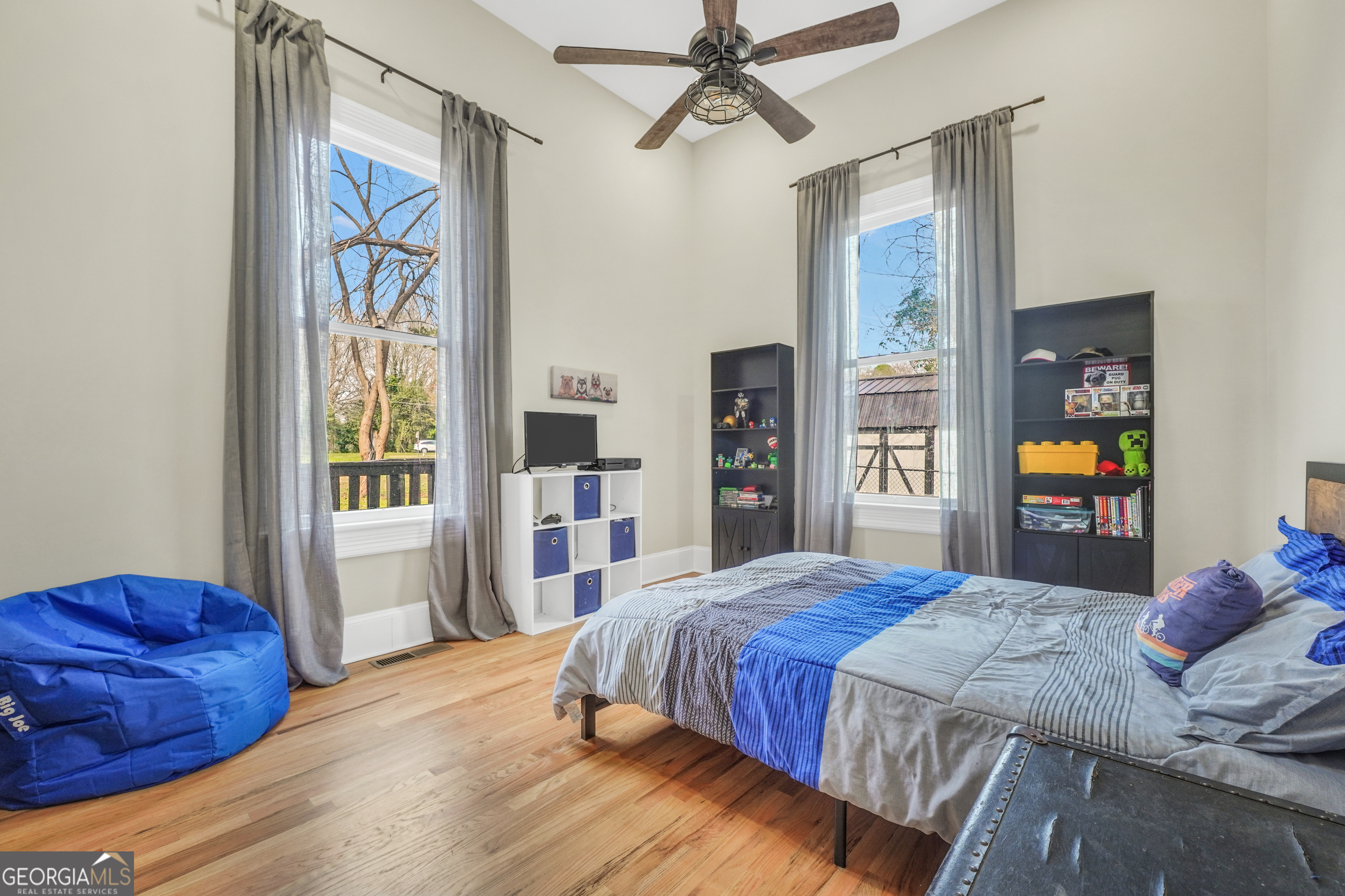 263 Julia Street Monticello, GA 31064 - Photo 43 of 48 a bedroom with a bed and a chandelier