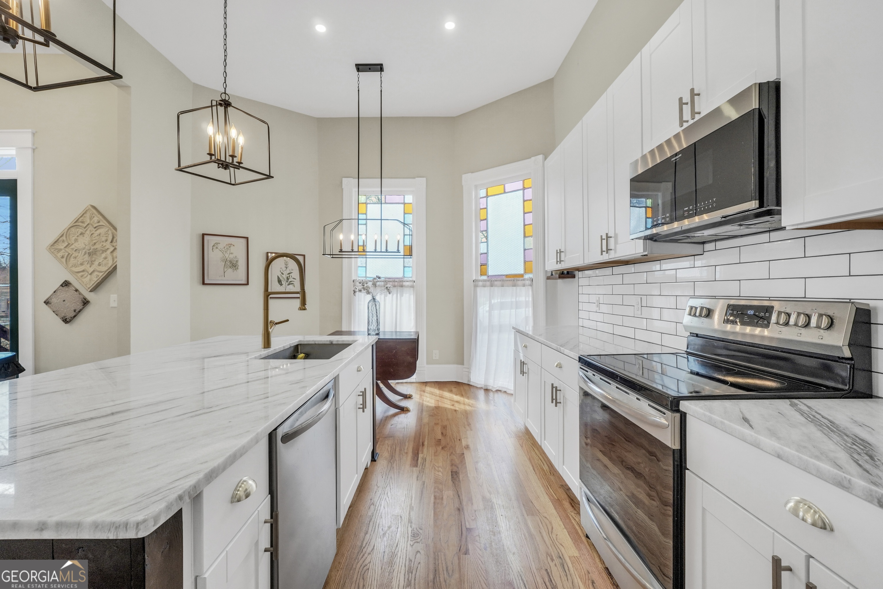 263 Julia Street Monticello, GA 31064 - Photo 10 of 48 a kitchen with stainless steel appliances granite countertop a stove a sink and a microwave