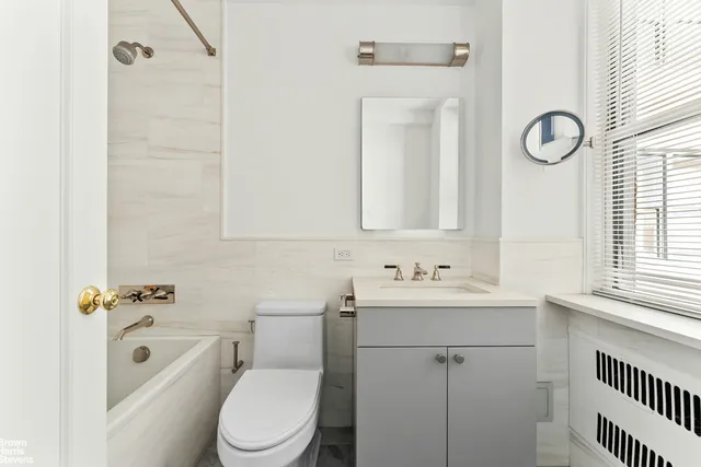 a bedroom with a bed and wooden cabinets