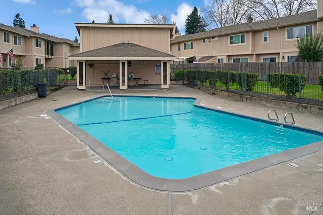 a view of a white house with a swimming pool