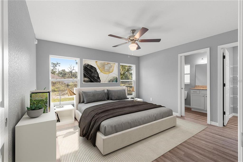 12472 Southeast 67th Terrace Road Belleview, FL 34420 - Photo 9 of 18 a bedroom with a large bed and a chandelier