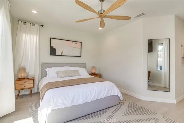 a bedroom with a large bed and a chandelier