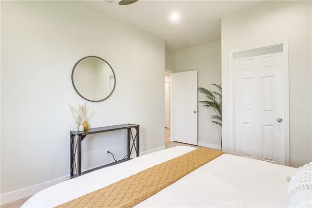 a bedroom with a bed and cabinets