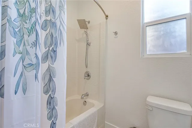 a bathroom with a bathtub and shower