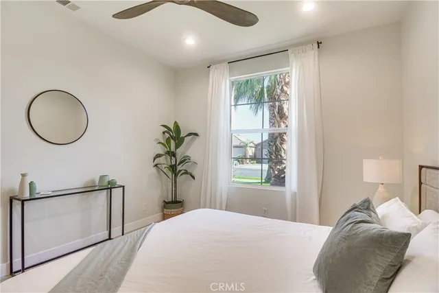 a bedroom with a large bed and a window