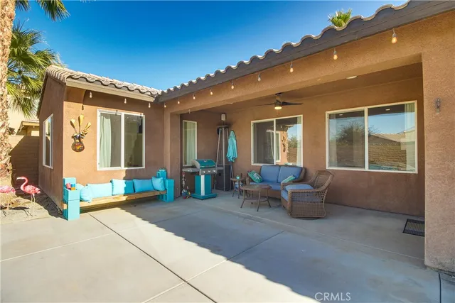 a view of a patio with dining table and chairs with wooden fence