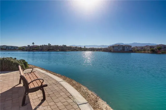 a view of a lake with table and chairs