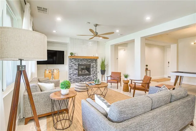 a living room with fireplace furniture and a flat screen tv