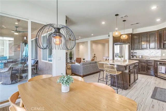 a large kitchen with a table and chairs