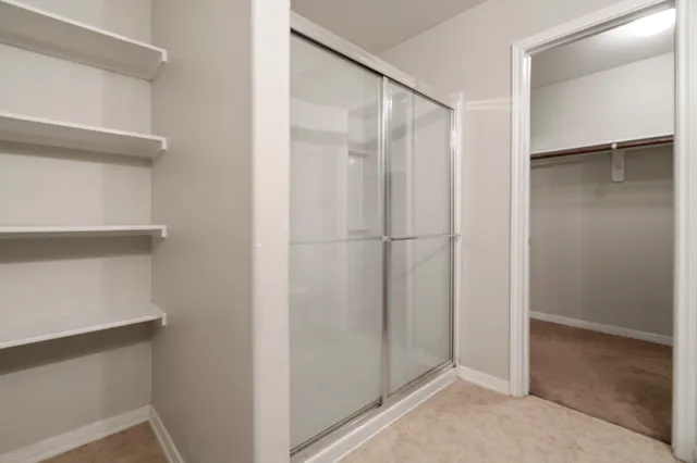 an empty room with closet and a ceiling fan