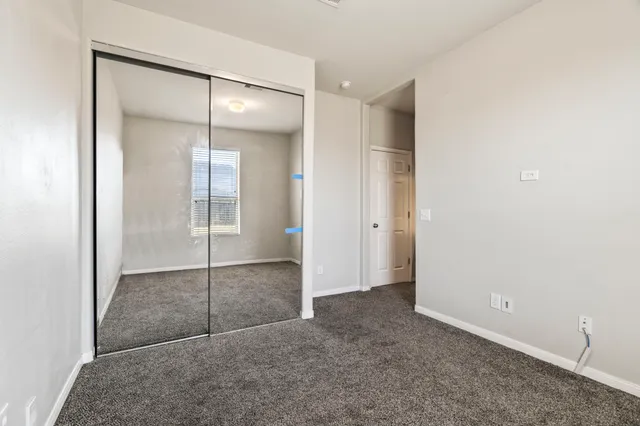 a view of kitchen with wooden floor and electronic appliances