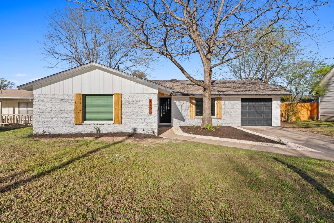 5408 Coventry Lane Austin, TX 78723 - Photo 1 of 1 a front view of a house with a garden and yard