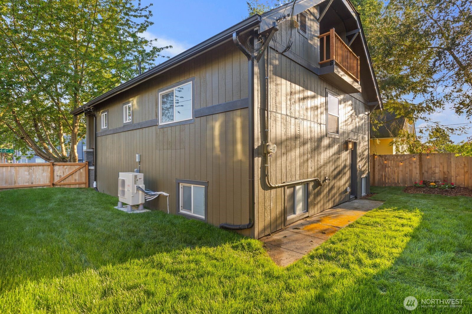 512 Northwest 44th Street Seattle, WA 98107 - Photo 32 of 37 a view of backyard with wooden fence and large trees