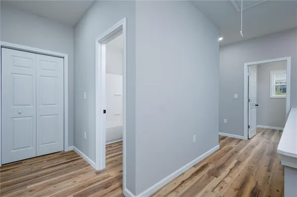 a view of hallway with wooden floor