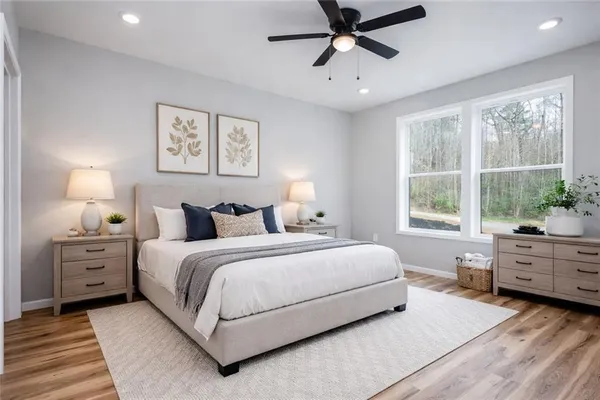a bedroom with a large bed and a window