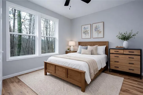 a spacious bedroom with a bed a window and painting on the wall