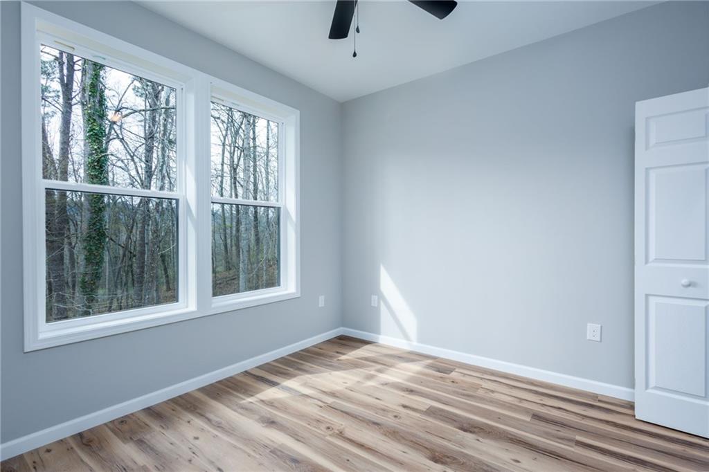 200 Back Pine Way, Unit B Ellijay, GA 30536 - Photo 25 of 29 a view of an empty room with wooden floor and windows