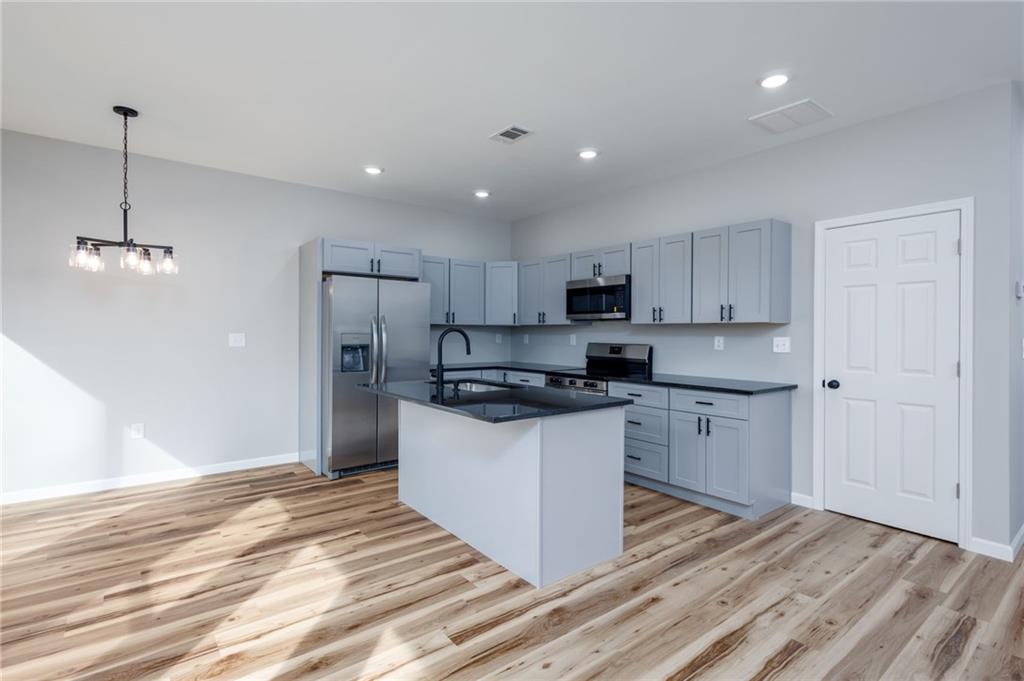 200 Back Pine Way, Unit B Ellijay, GA 30536 - Photo 3 of 29 a kitchen with stainless steel appliances granite countertop a sink a stove a refrigerator and white cabinets