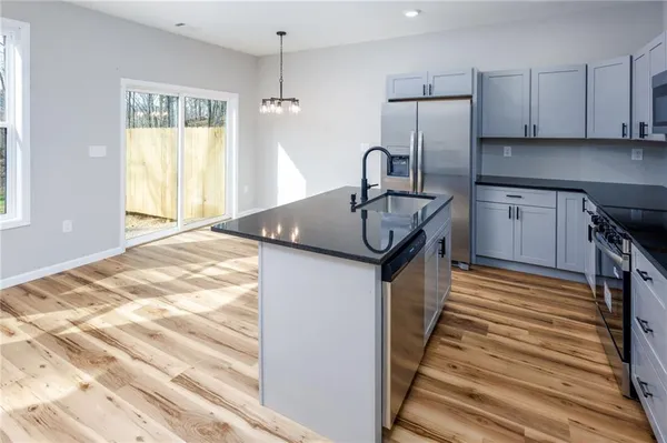 a kitchen with granite countertop a sink and cabinets