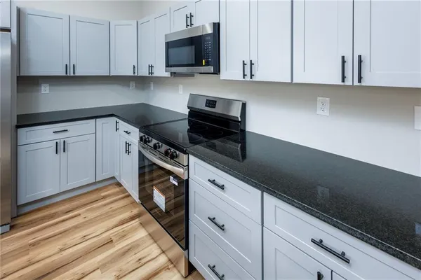 a kitchen with cabinets appliances and a sink