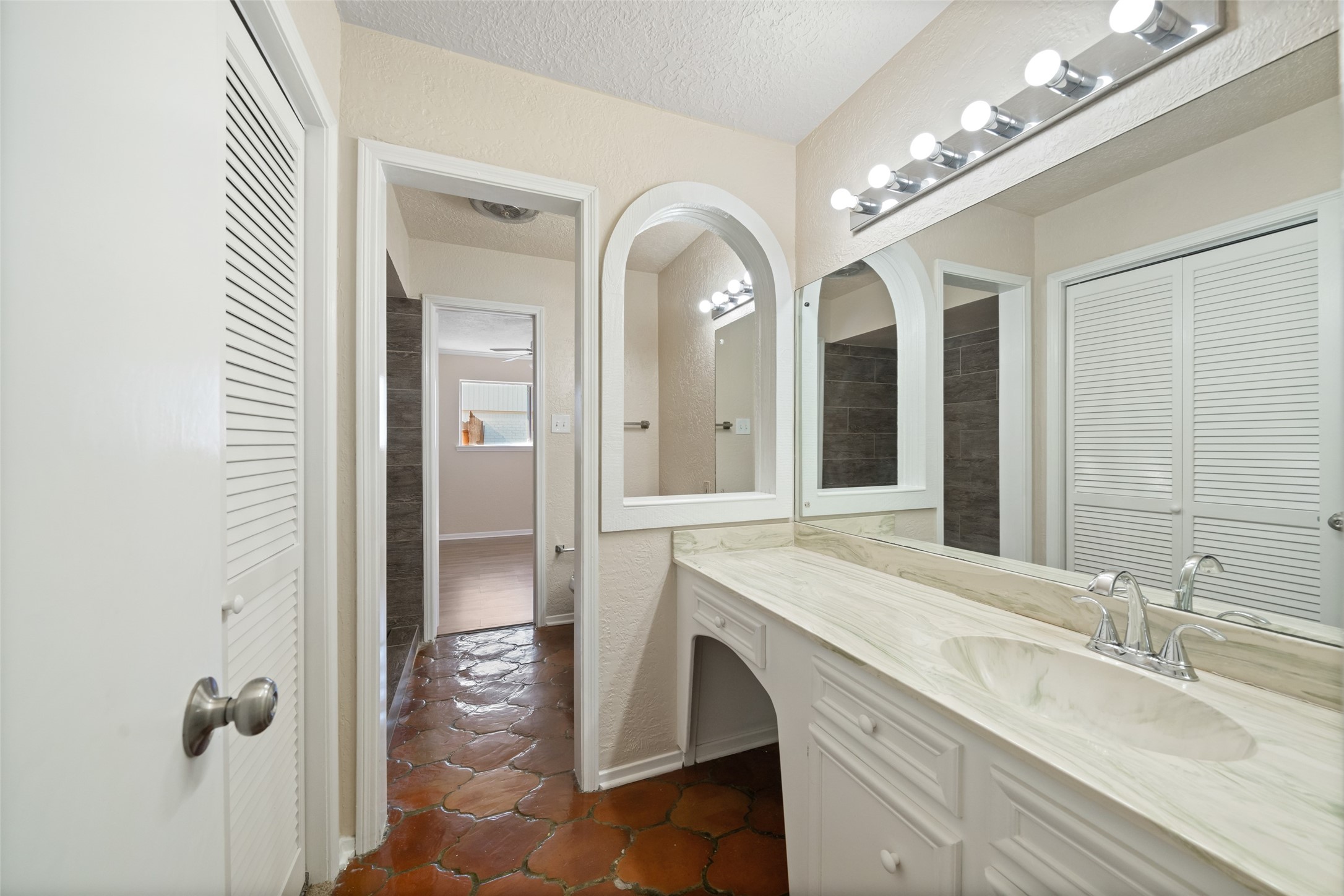 19218 Enchanted Oaks Drive Spring, TX 77388 - Photo 11 of 20 a spacious bathroom with a granite countertop sink a mirror and shower