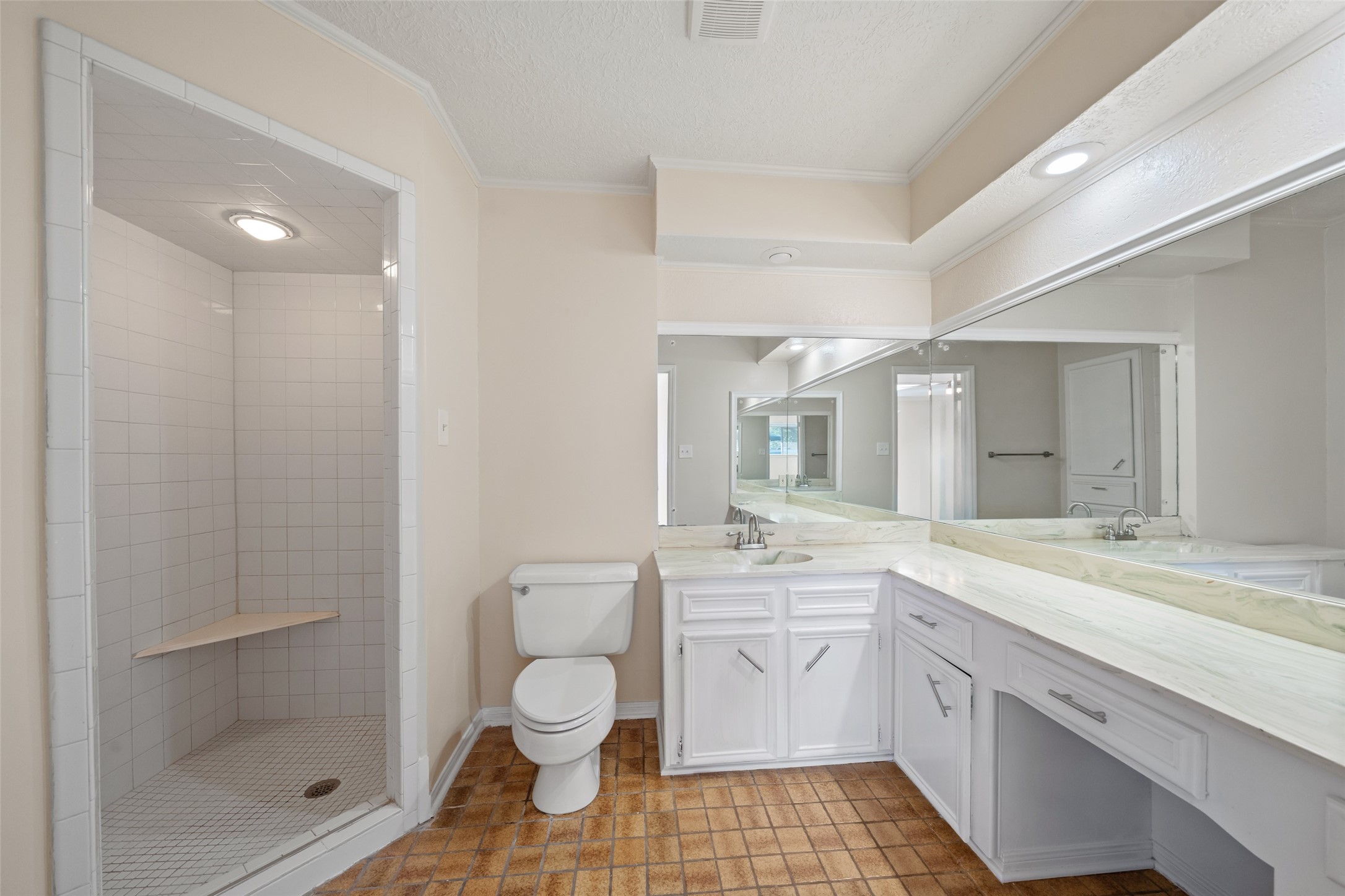 19218 Enchanted Oaks Drive Spring, TX 77388 - Photo 13 of 20 a spacious bathroom with a sink toilet a shower and a mirror