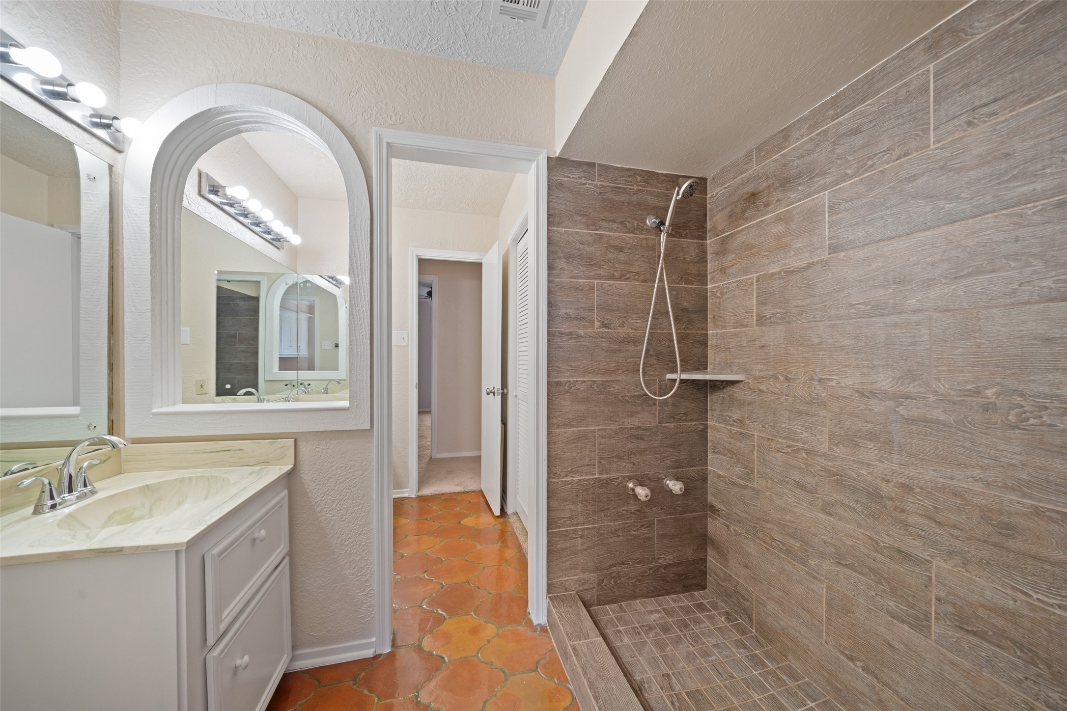 19218 Enchanted Oaks Drive Spring, TX 77388 - Photo 15 of 20 a bathroom with a double vanity sink toilet and shower