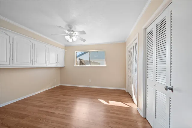 a view of a kitchen with wooden floor and a window