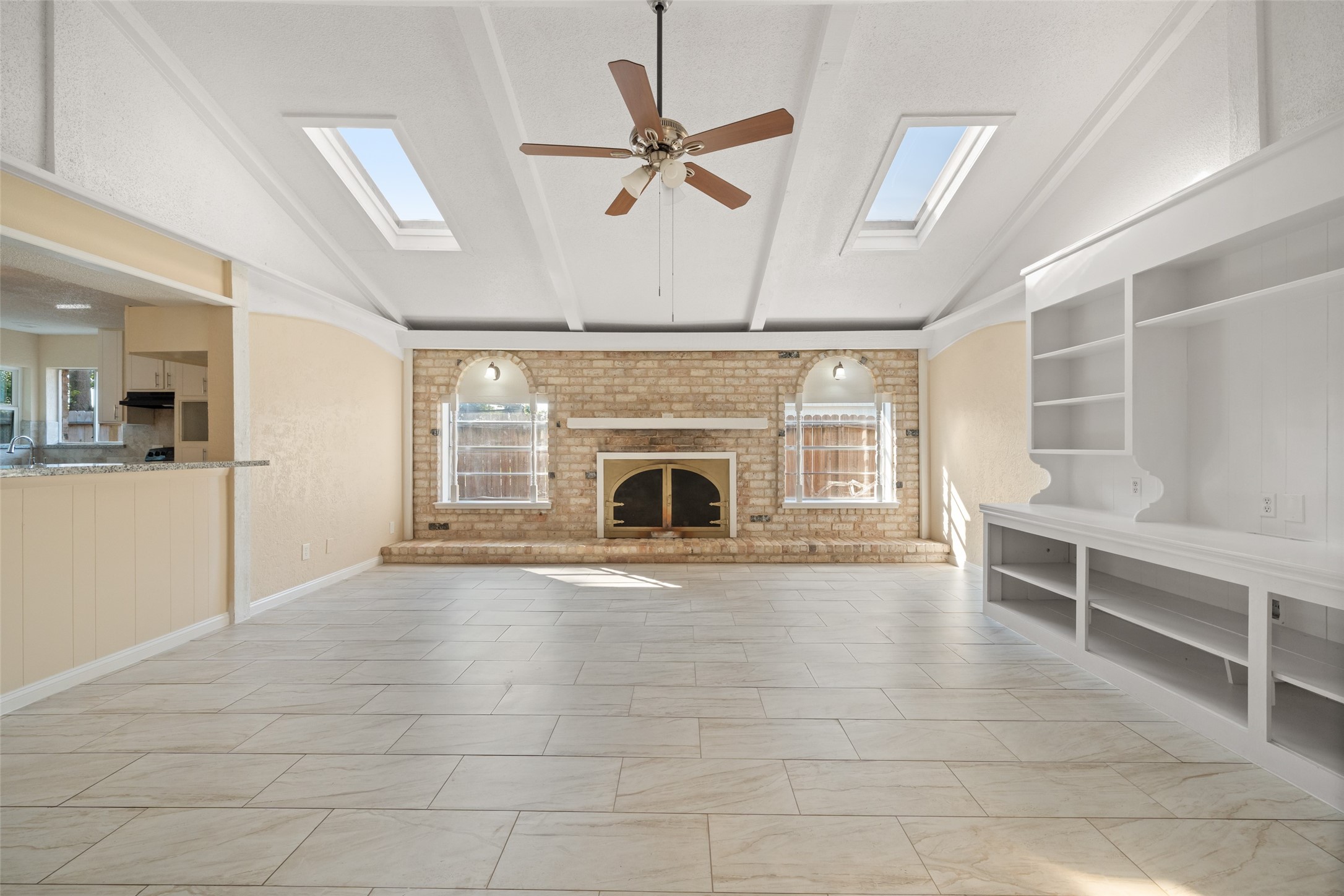 19218 Enchanted Oaks Drive Spring, TX 77388 - Photo 5 of 20 a view of an empty room with a fireplace and a ceiling fan