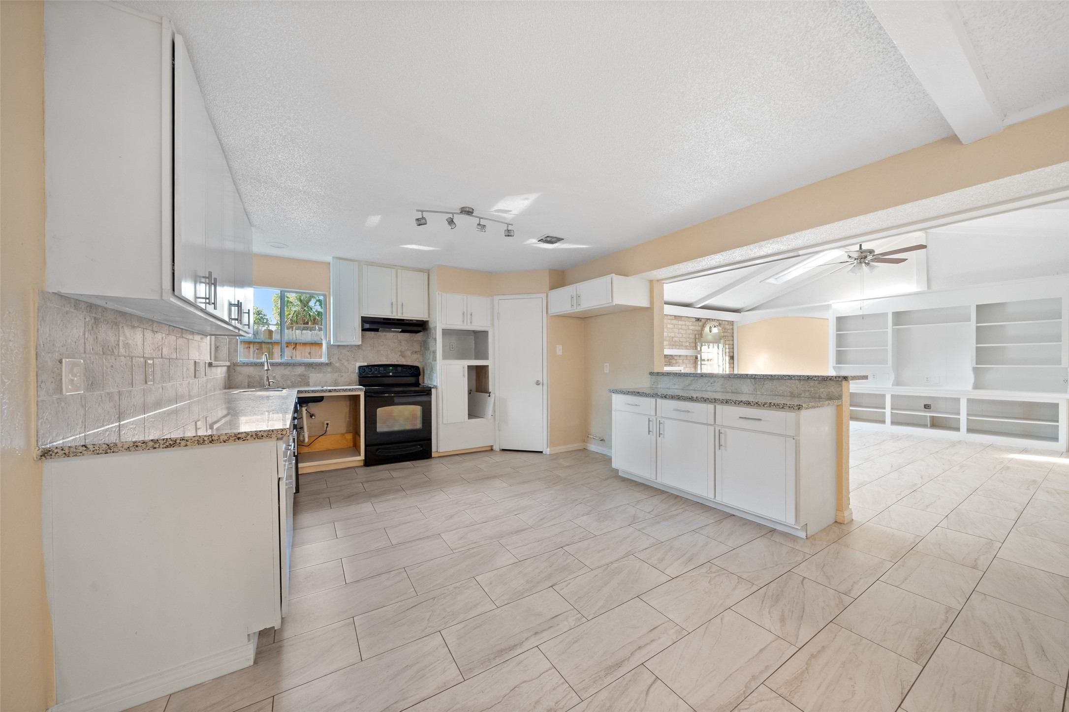 19218 Enchanted Oaks Drive Spring, TX 77388 - Photo 7 of 20 a large kitchen with cabinets and a stove