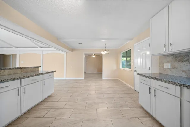 a large bathroom with a granite countertop sink and a bathtub