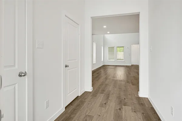 a view of a hallway with wooden floor