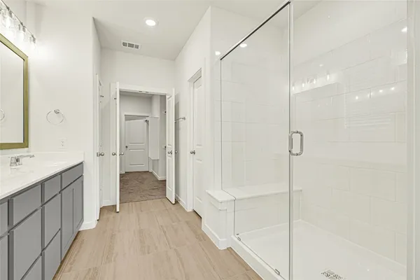 a bathroom with a shower and a sink