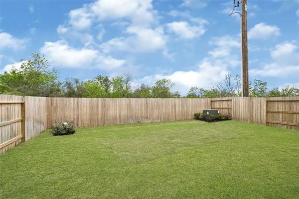 a view of a backyard with a fence