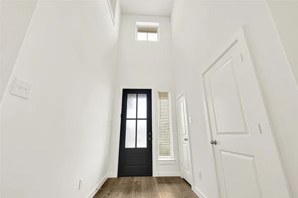 a view of front door with wooden floor