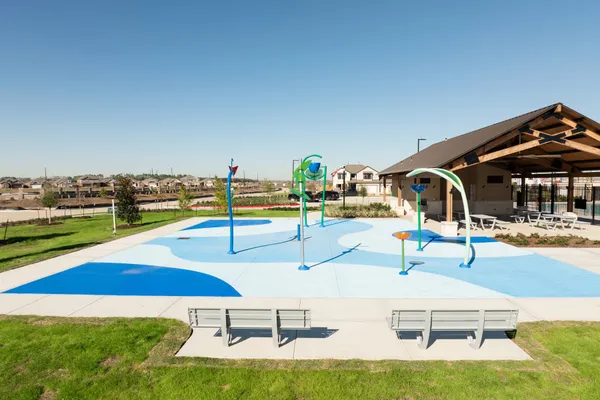 a view of a swimming pool with a bench and lawn chairs
