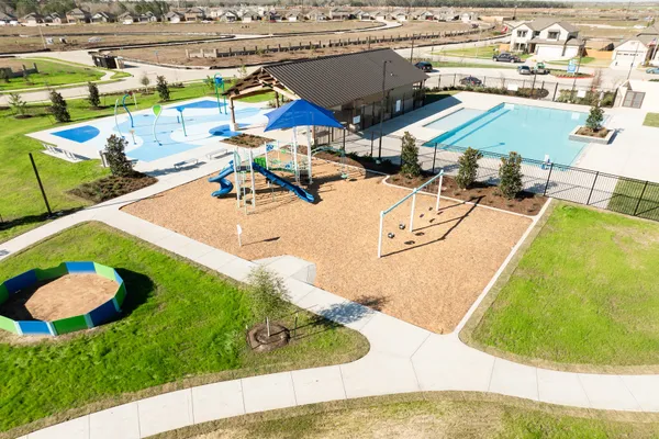 a view of a swimming pool with a patio and seating area