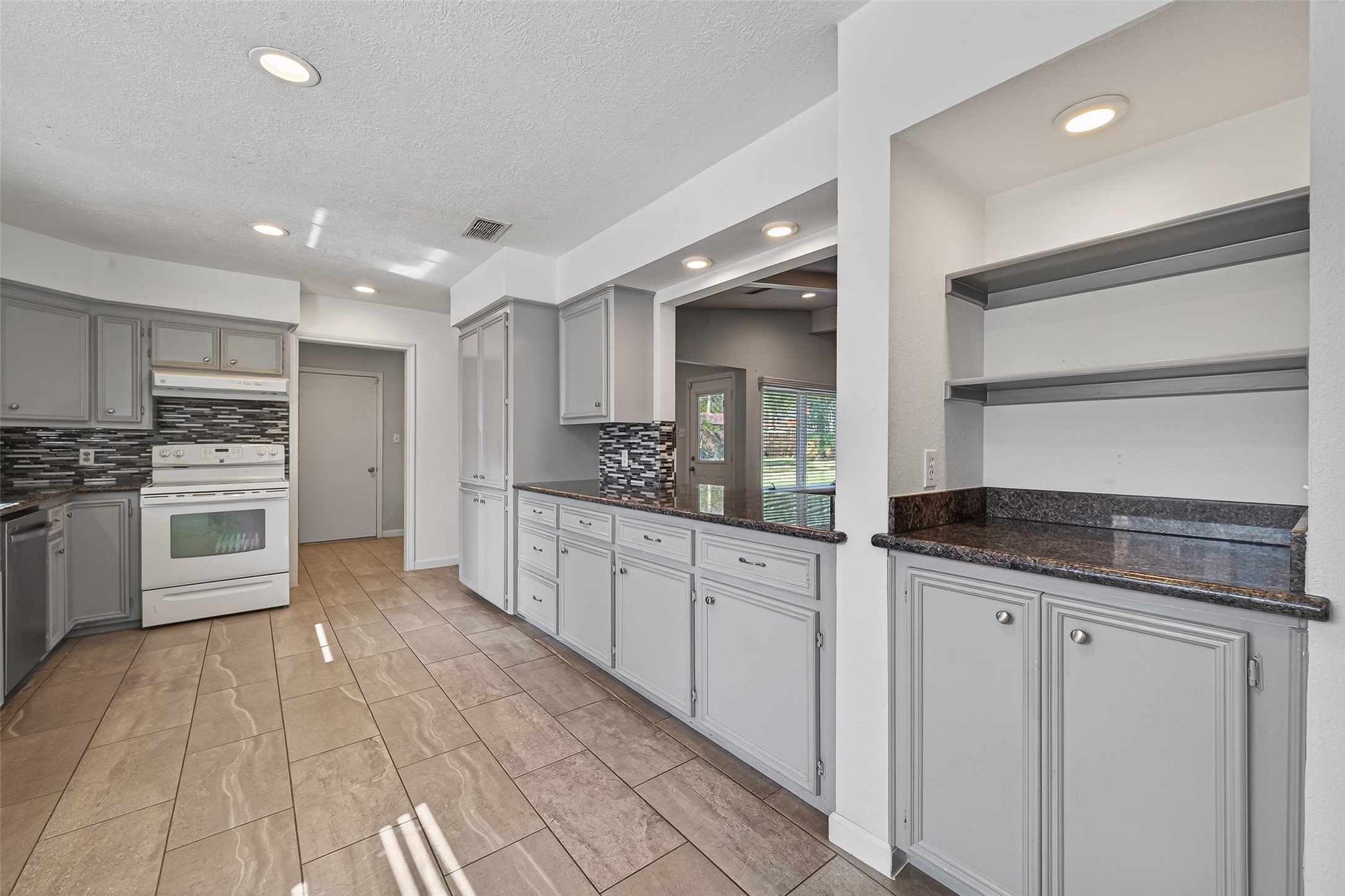 11811 Beverly Drive Houston, TX 77065 - Photo 11 of 48 a large kitchen with stainless steel appliances a stove a sink and a refrigerator