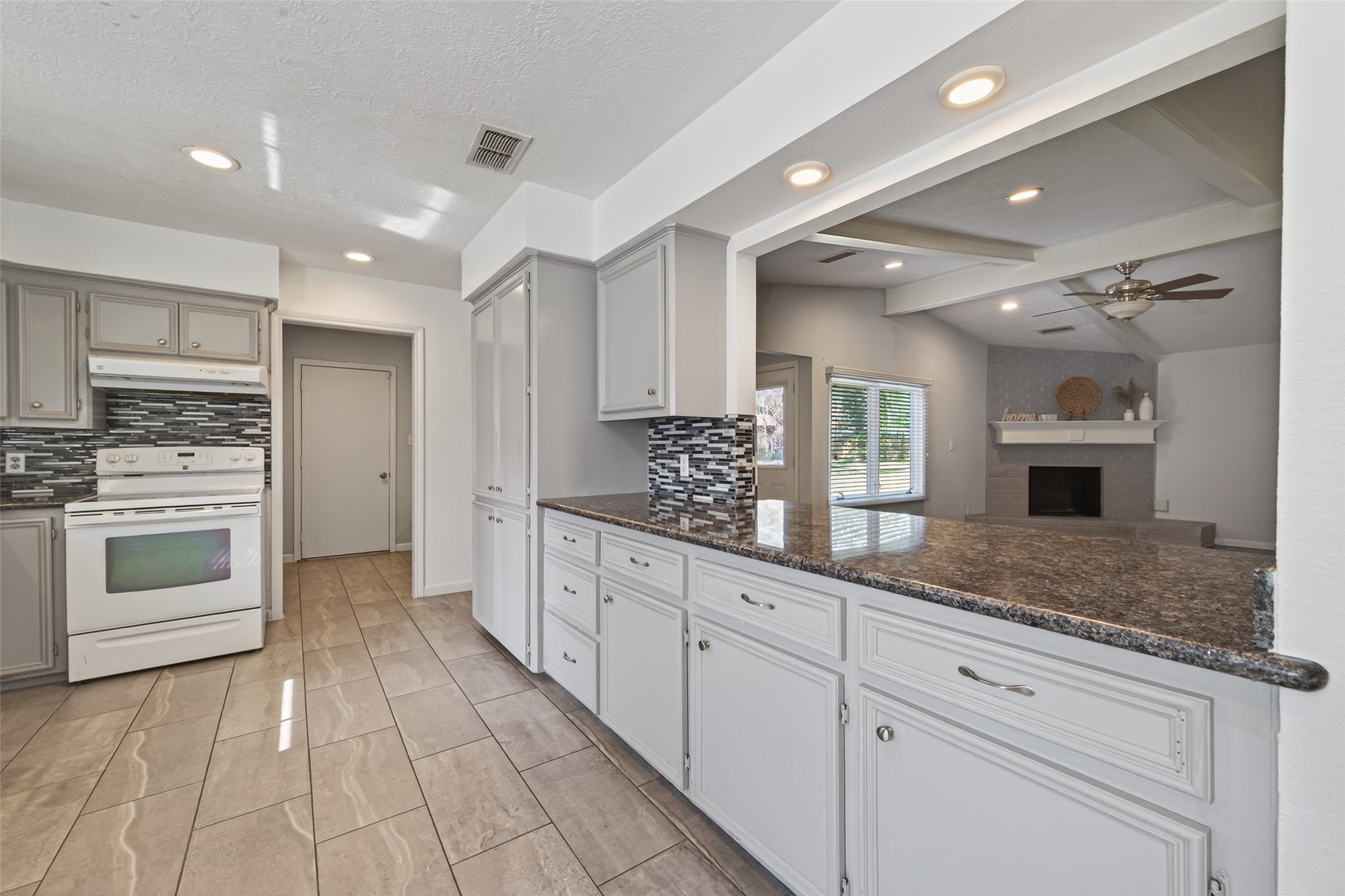 11811 Beverly Drive Houston, TX 77065 - Photo 12 of 48 a kitchen with granite countertop cabinets stainless steel appliances and a counter space