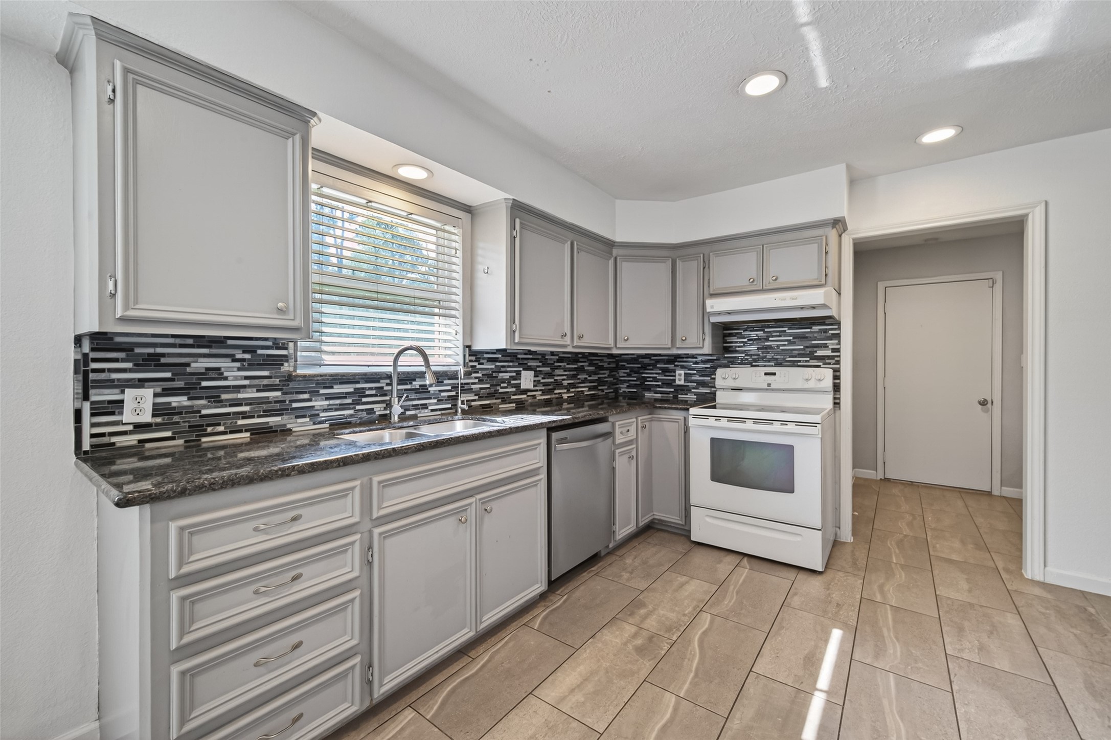 11811 Beverly Drive Houston, TX 77065 - Photo 14 of 48 a kitchen with granite countertop a sink stainless steel appliances and cabinets