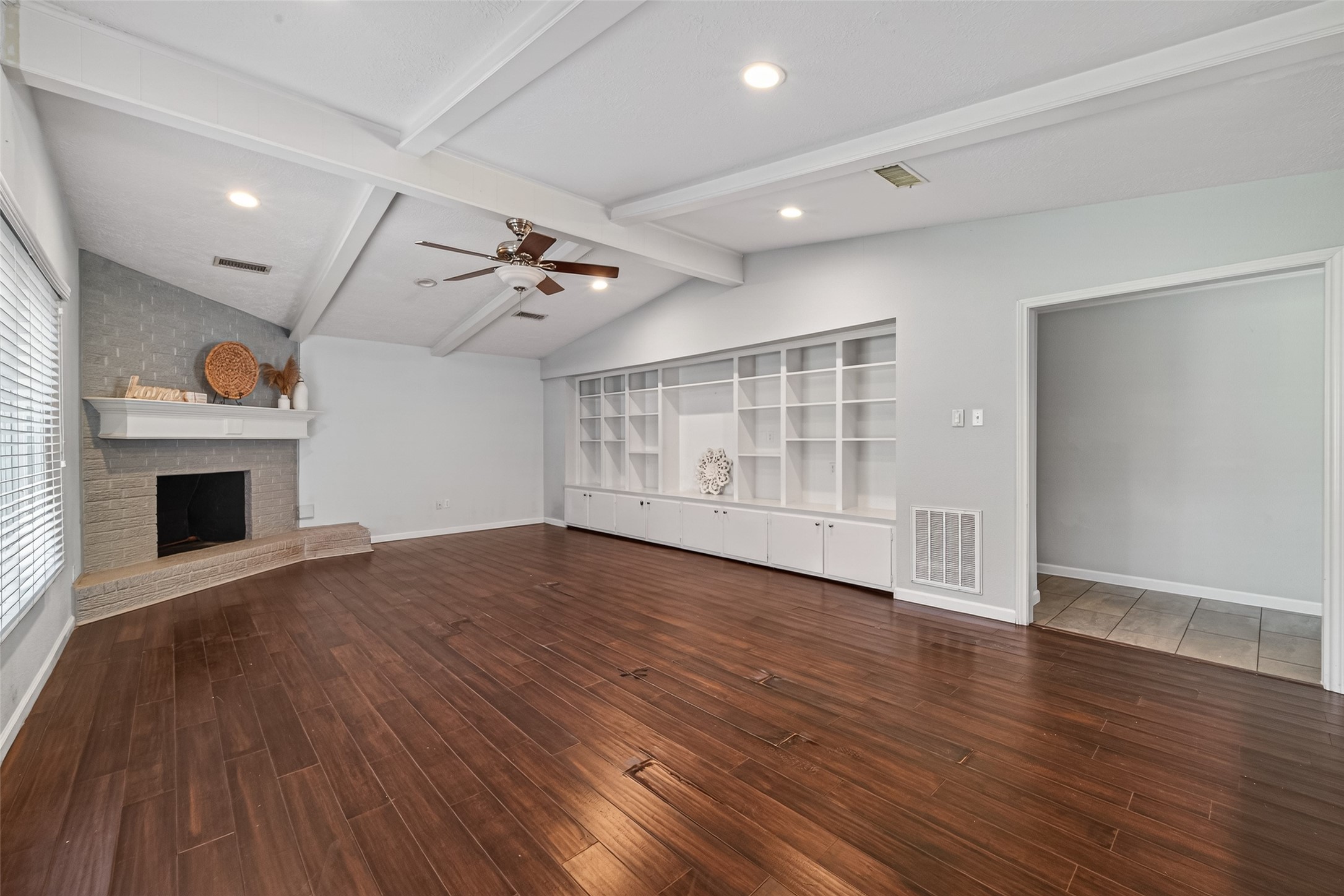 11811 Beverly Drive Houston, TX 77065 - Photo 23 of 48 a view of an empty room with wooden floor fireplace and a window