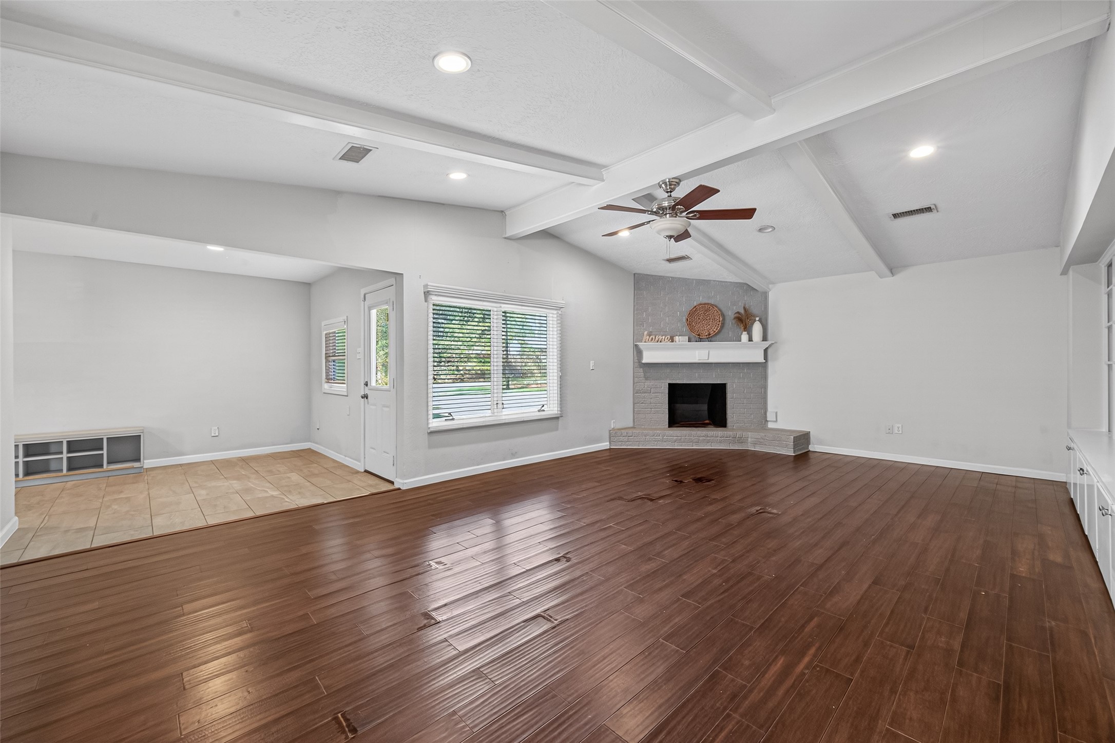 11811 Beverly Drive Houston, TX 77065 - Photo 24 of 48 an empty room with wooden floor chandelier fan and windows