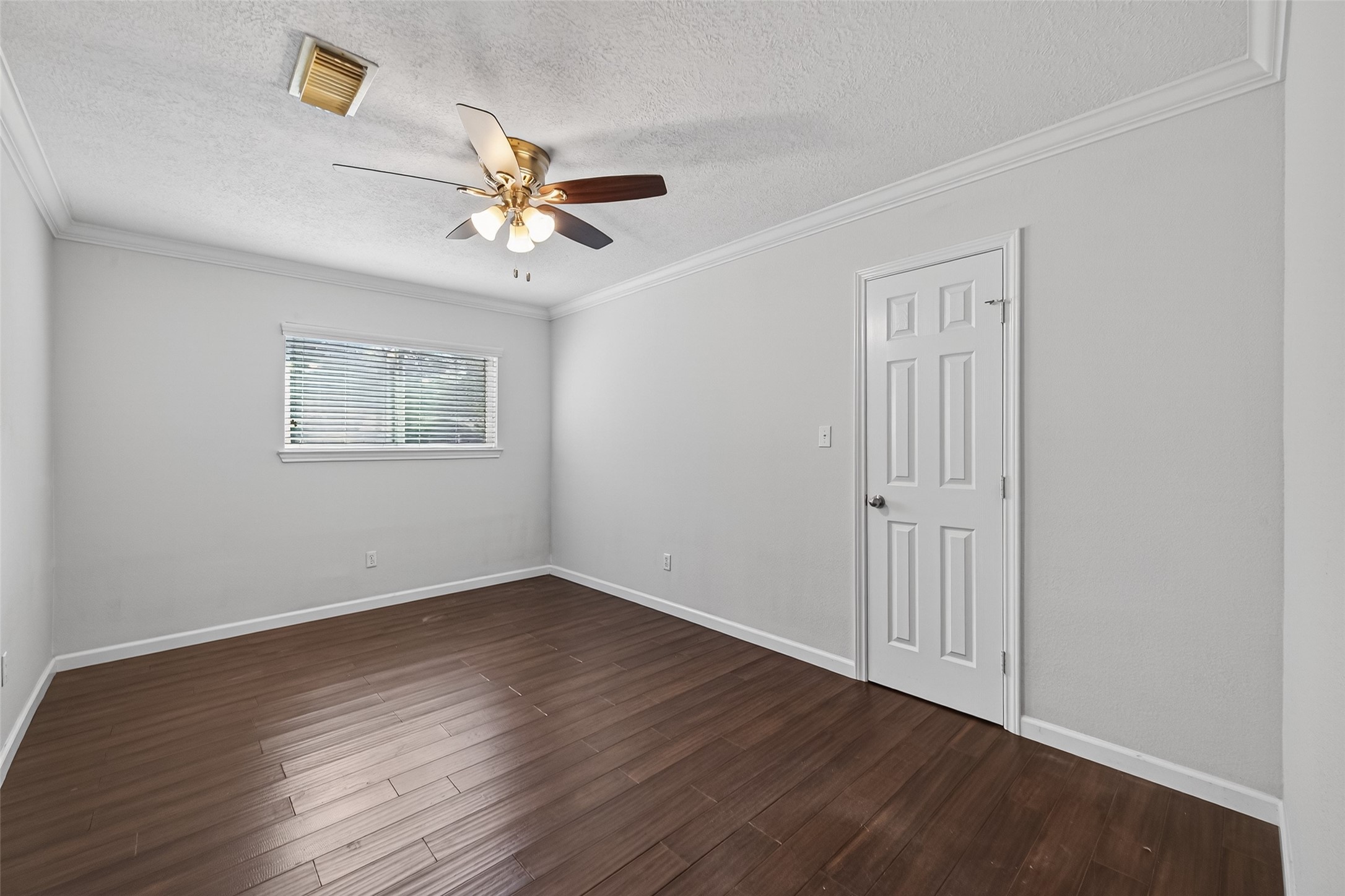 11811 Beverly Drive Houston, TX 77065 - Photo 29 of 48 a view of an empty room with a window and wooden floor